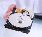 someone holding a hard drive in hand