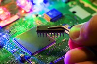 hand inserting chip into circuit board